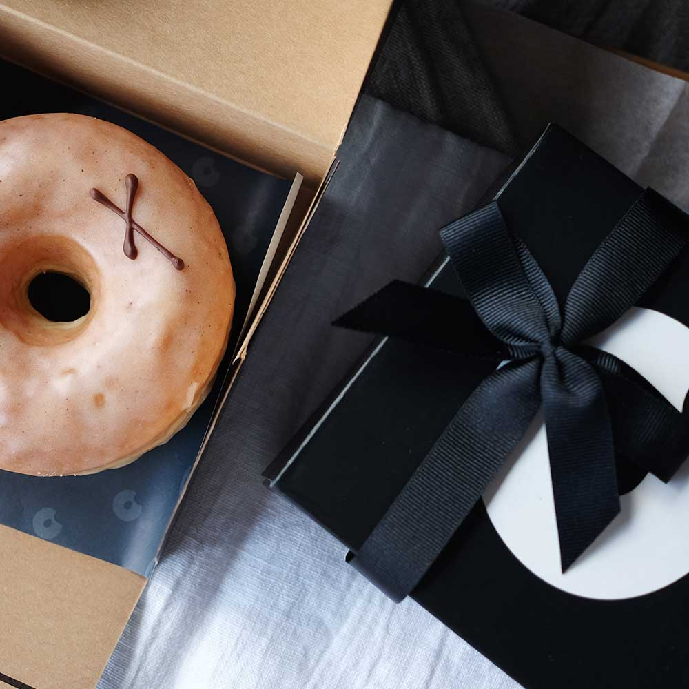 Box with vanilla doughnut inside