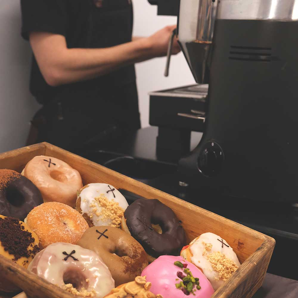 Crosstown seasonal doughnuts on display at a coffee bar